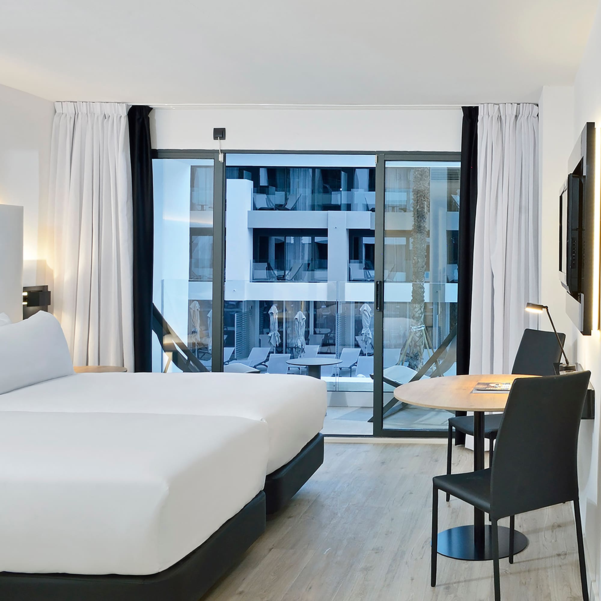 a room with two beds and a table