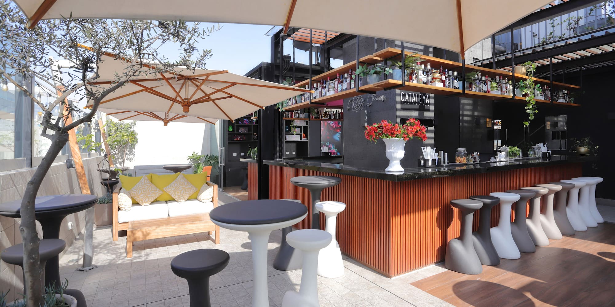 a bar with white tables and umbrellas