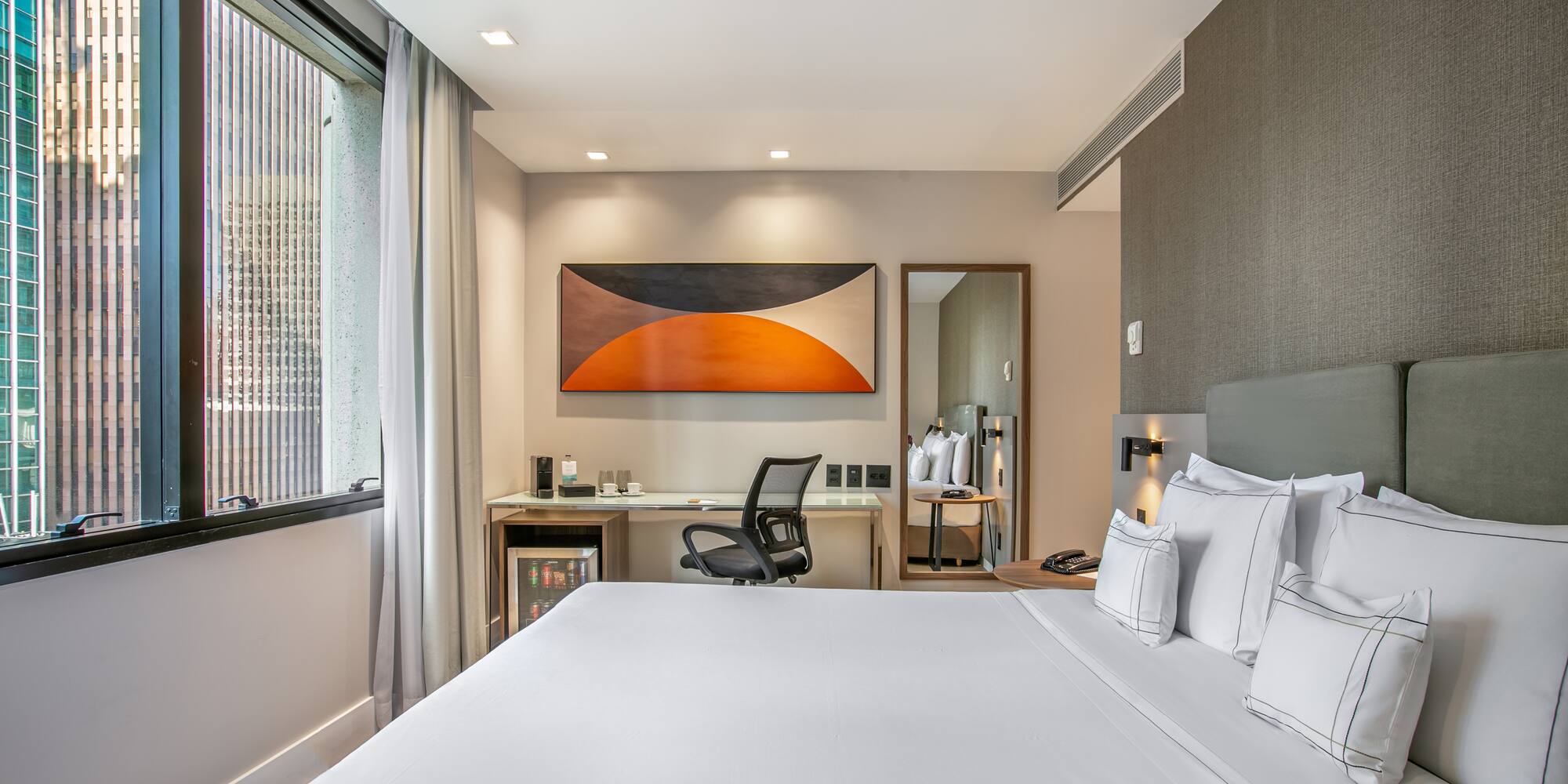 a bed with white sheets and a chair in a room