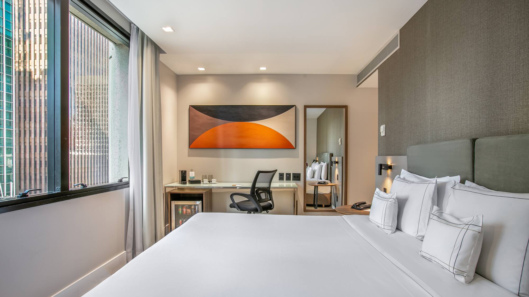 a bed with white sheets and a chair in a room