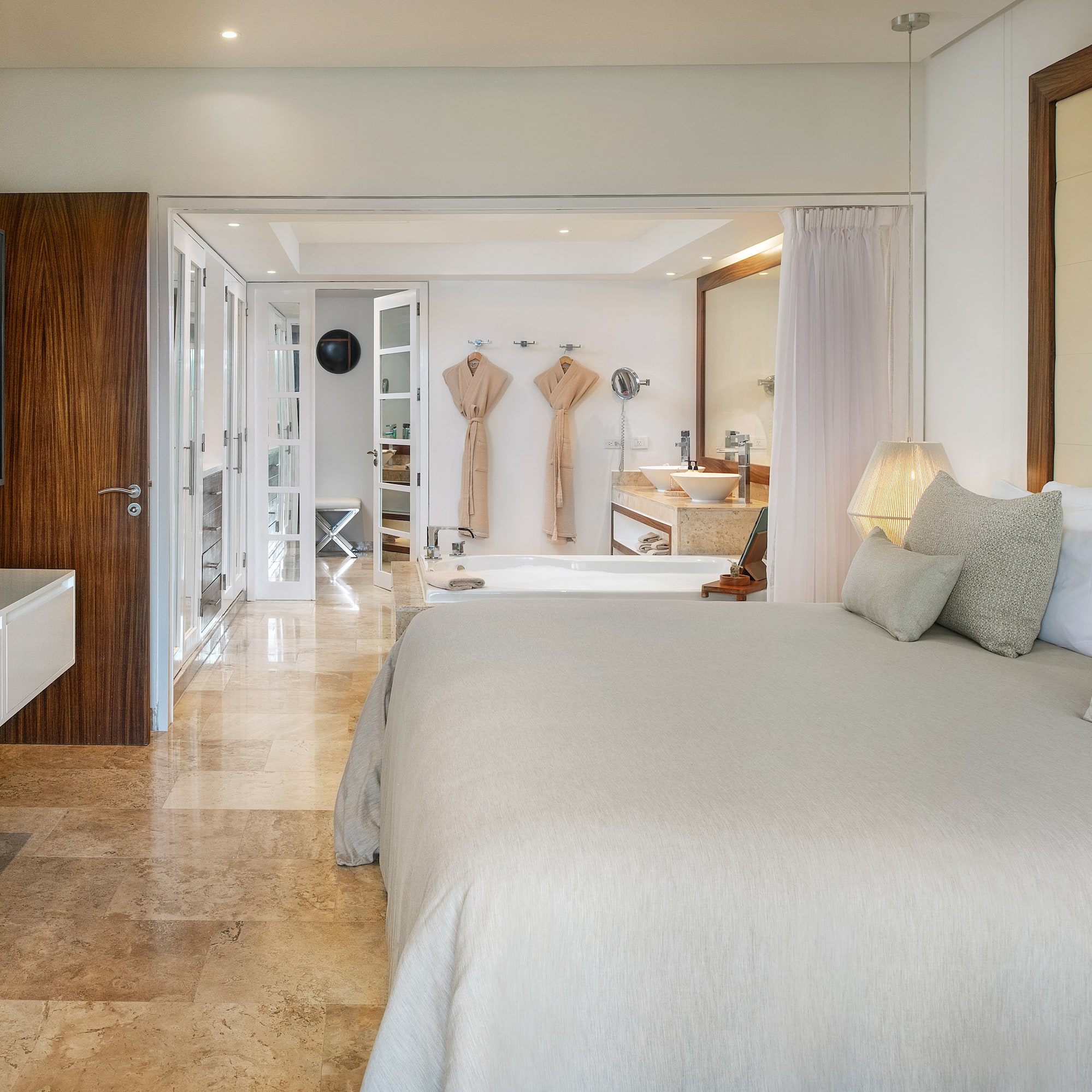 a bedroom with a large bed and a bathtub