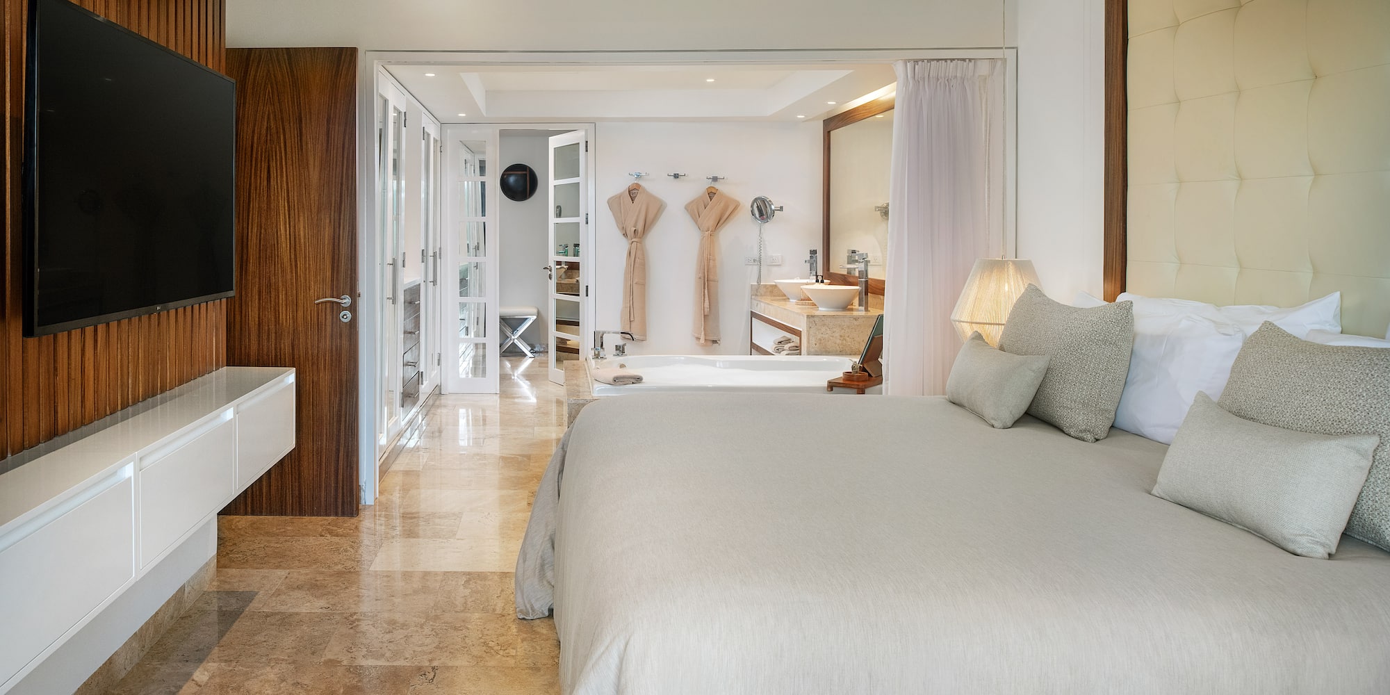 a bedroom with a large bed and a bathtub