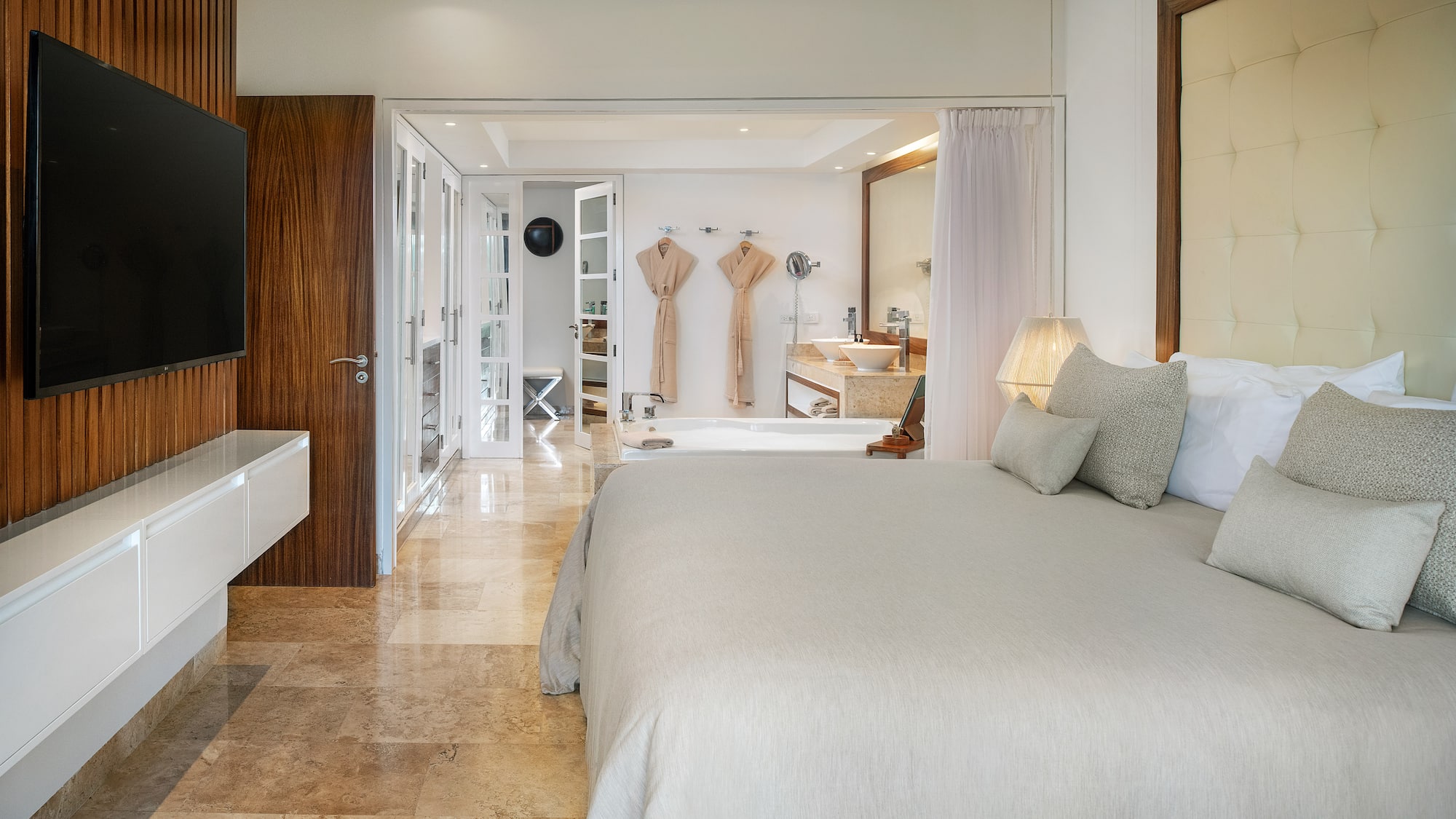 a bedroom with a large bed and a bathtub