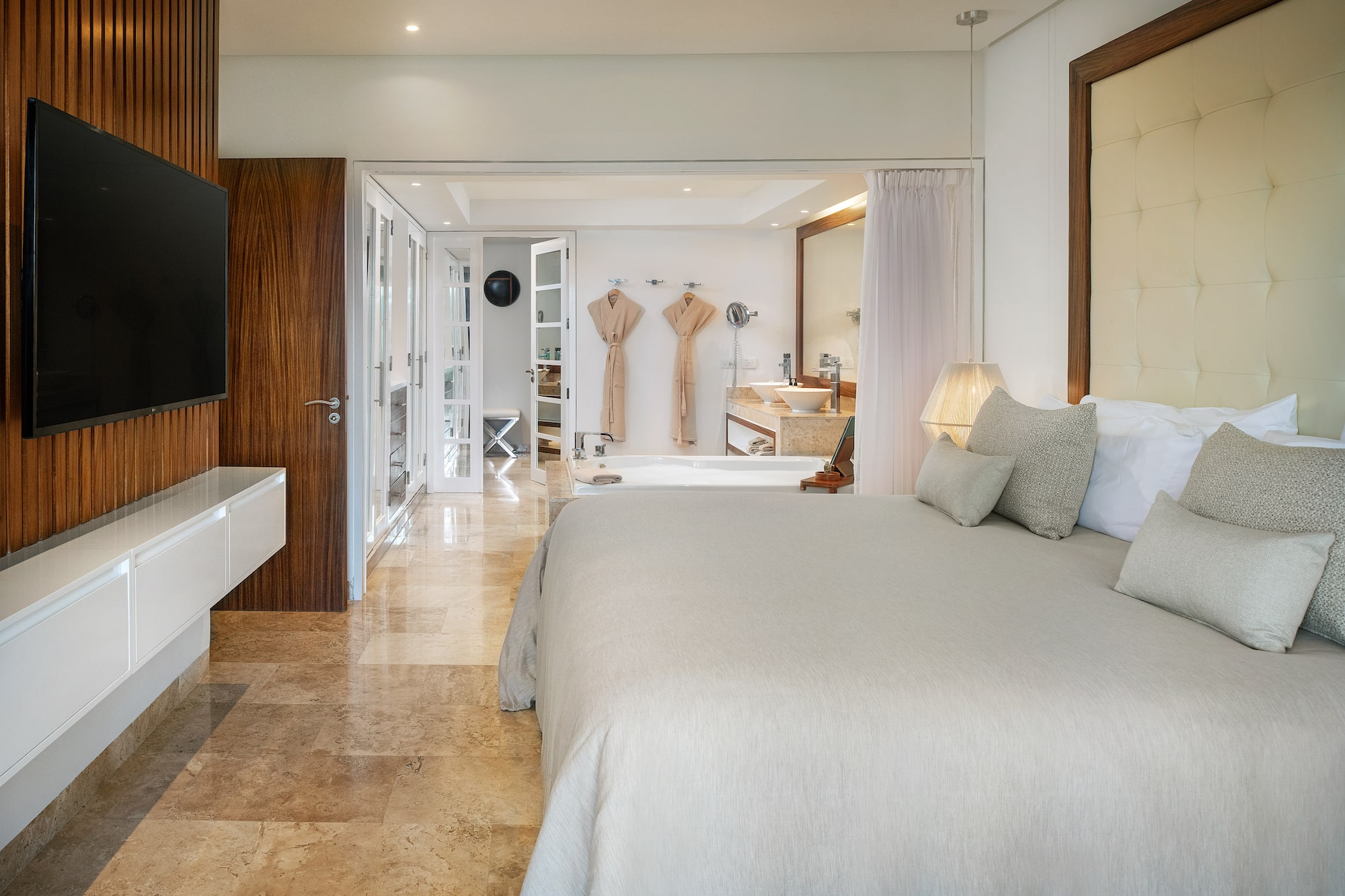 a bedroom with a large bed and a bathtub