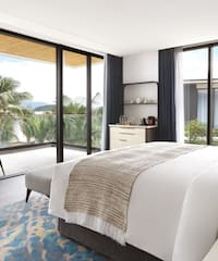 a bedroom with glass doors and a bed