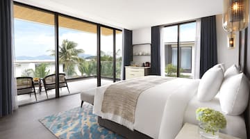 a bedroom with glass doors and a bed