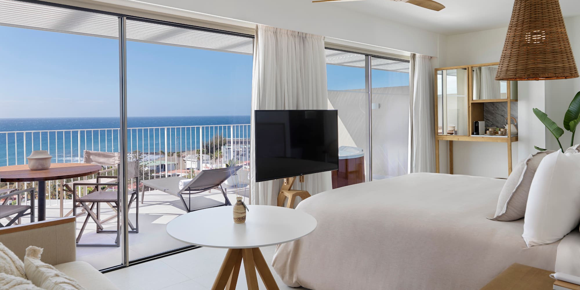 a bedroom with a television and a large window