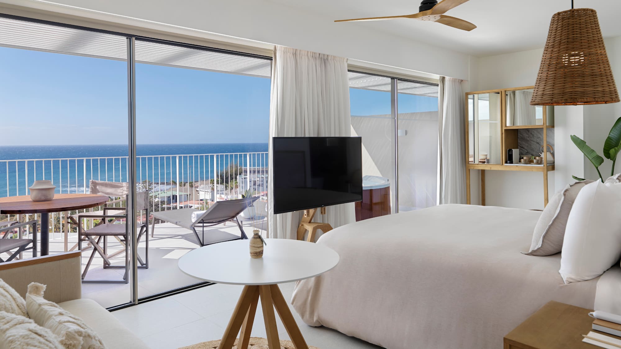 a bedroom with a television and a large window