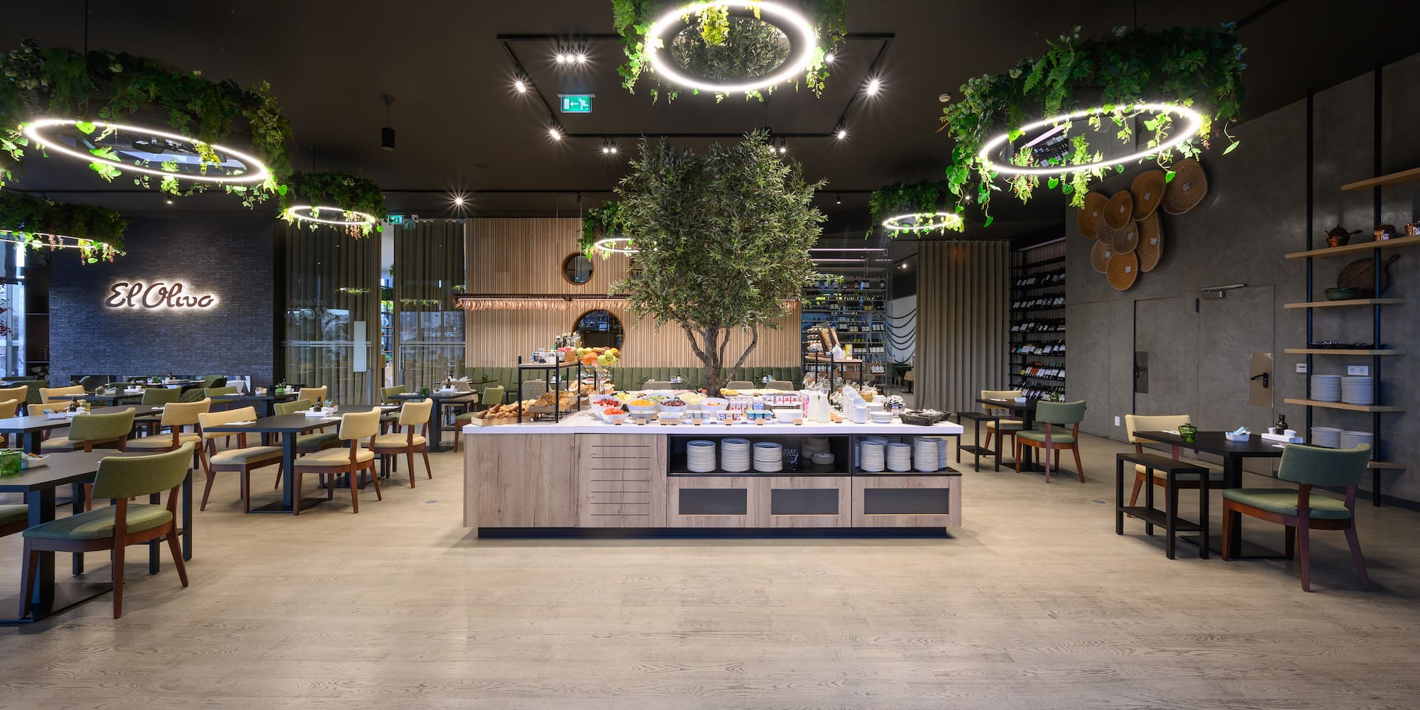 a room with a table and chairs and a tree