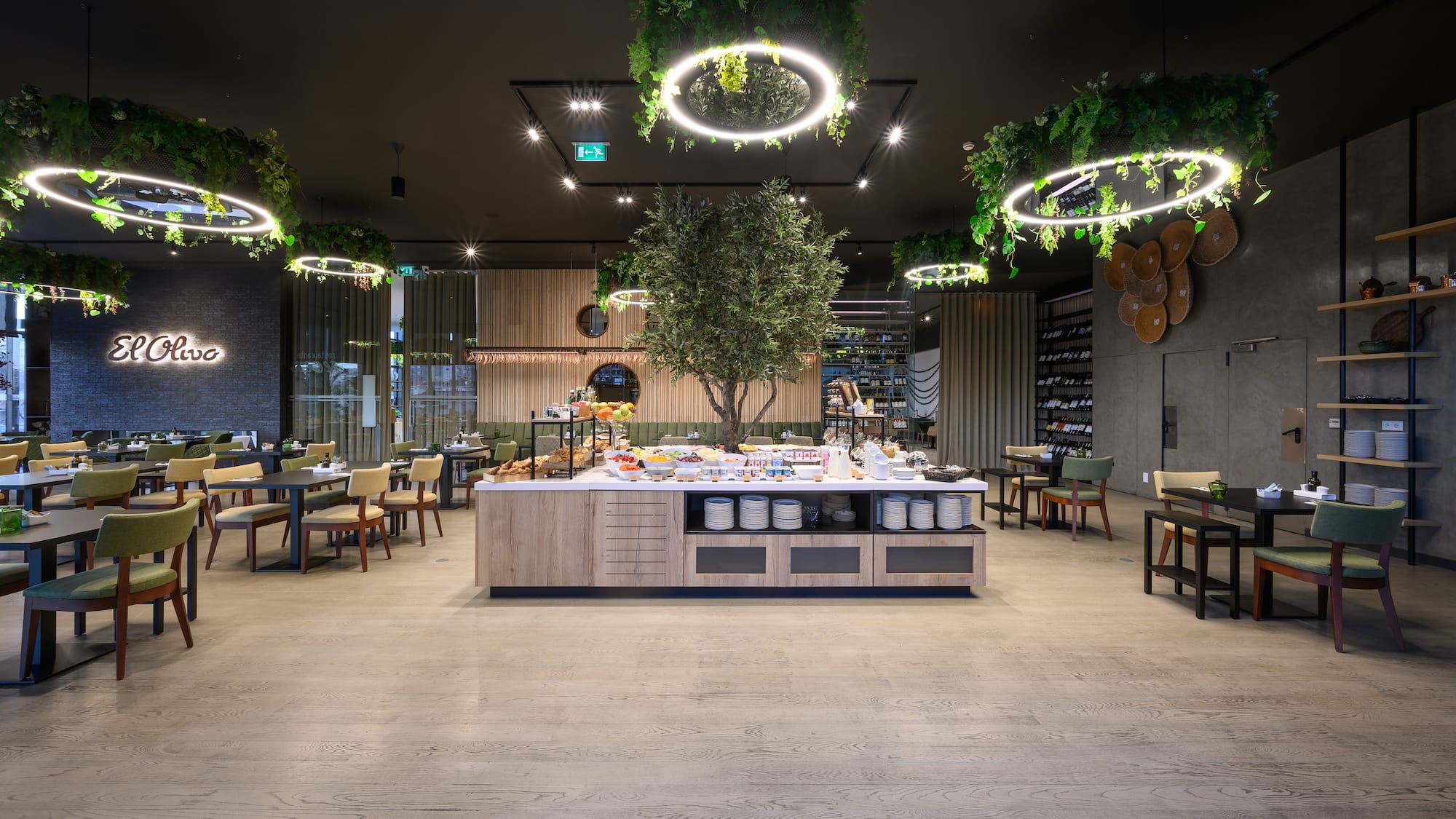 a room with a table and chairs and a tree