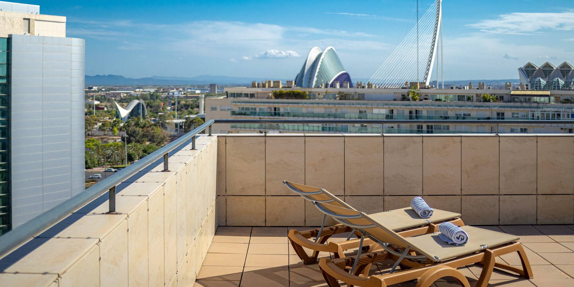 chairs on a rooftop overlooking a city