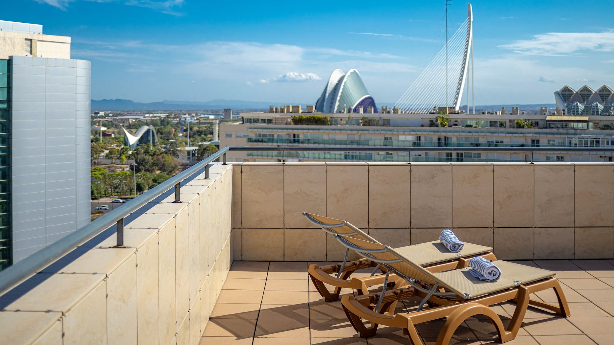 chairs on a rooftop overlooking a city