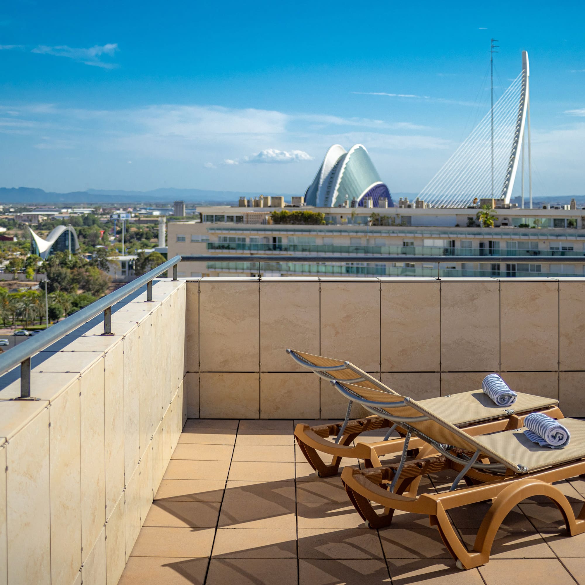 chairs on a rooftop overlooking a city