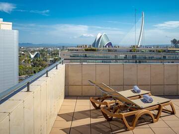 chairs on a rooftop overlooking a city