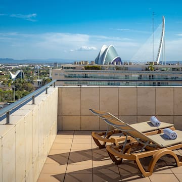 chairs on a rooftop overlooking a city