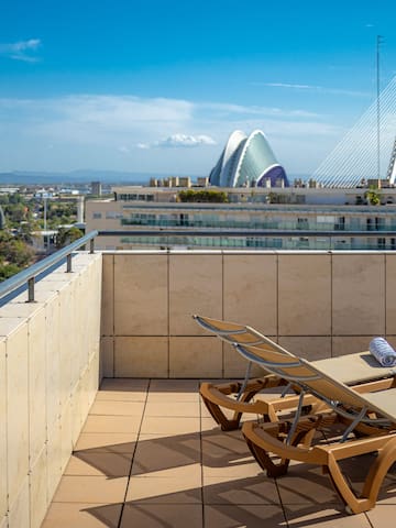 chairs on a rooftop overlooking a city