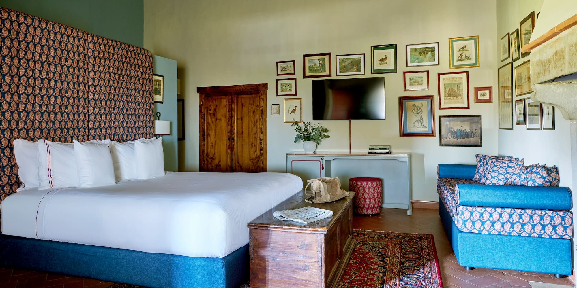 a room with a bed and a television