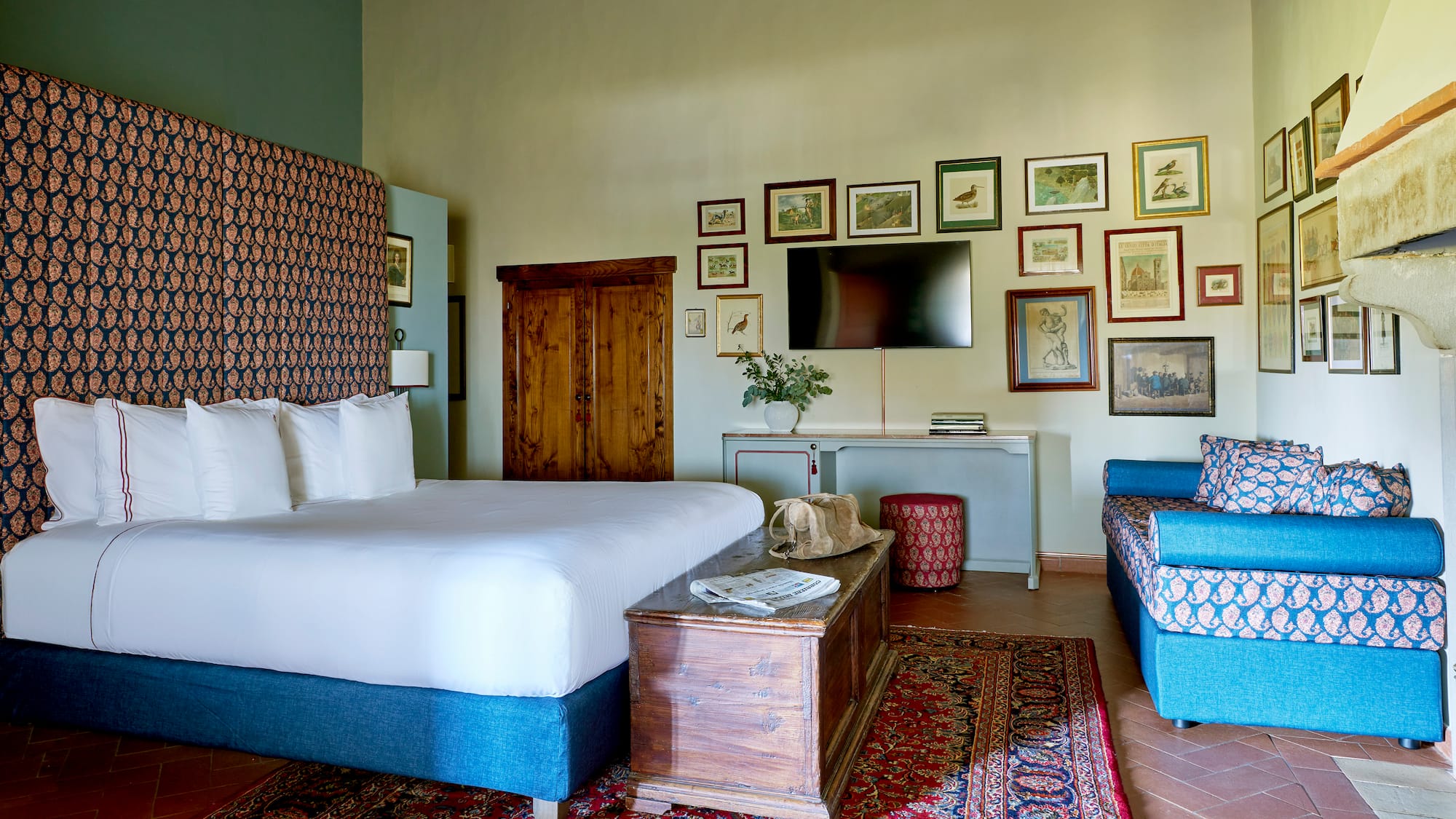 a room with a bed and a television