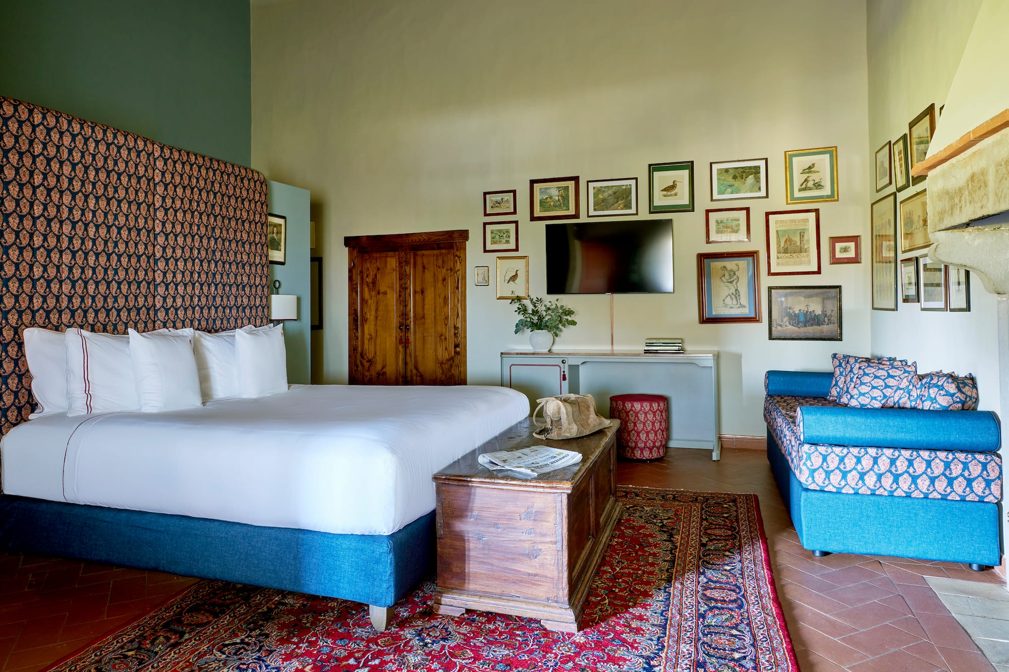 a room with a bed and a television