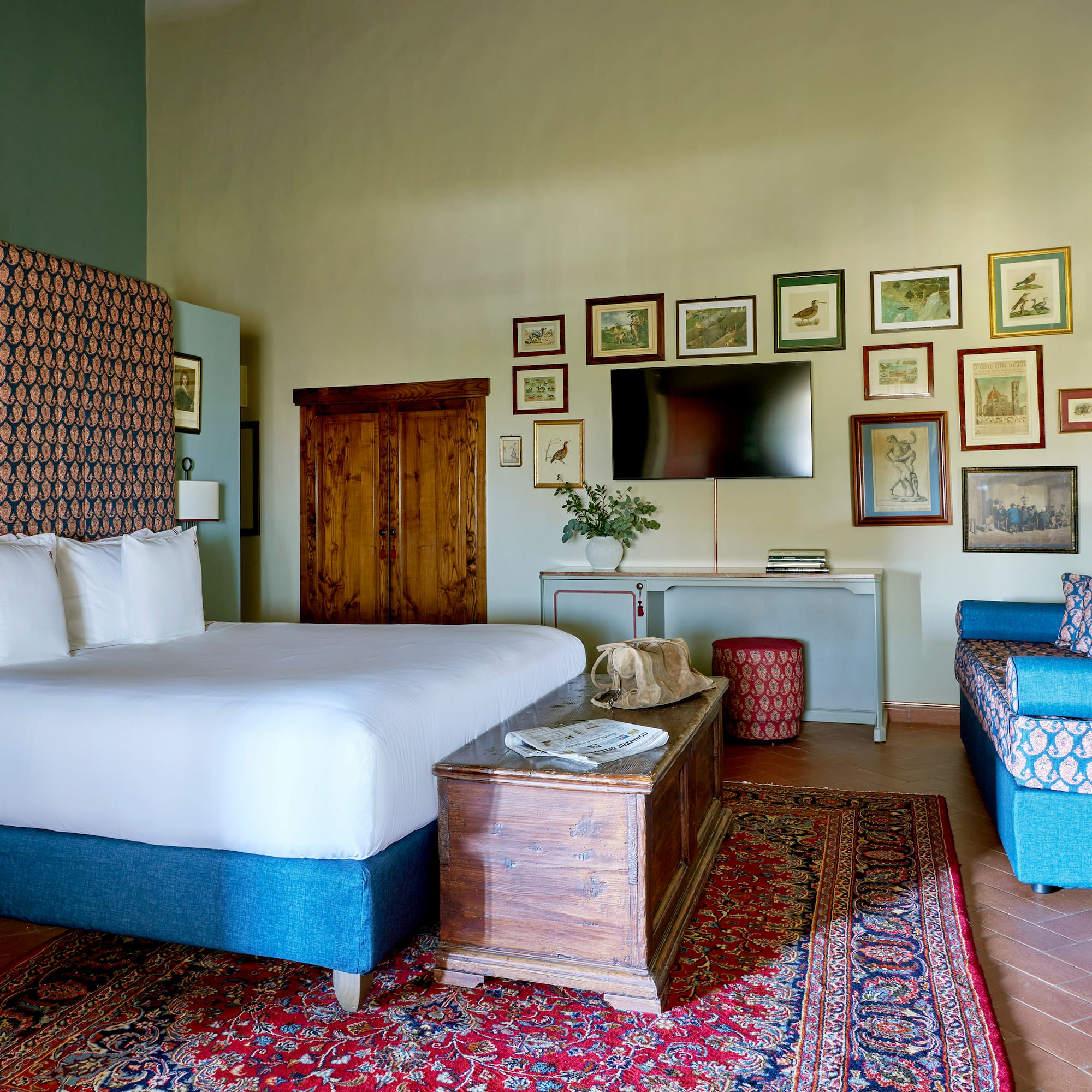 a room with a bed and a television