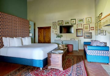 a room with a bed and a television