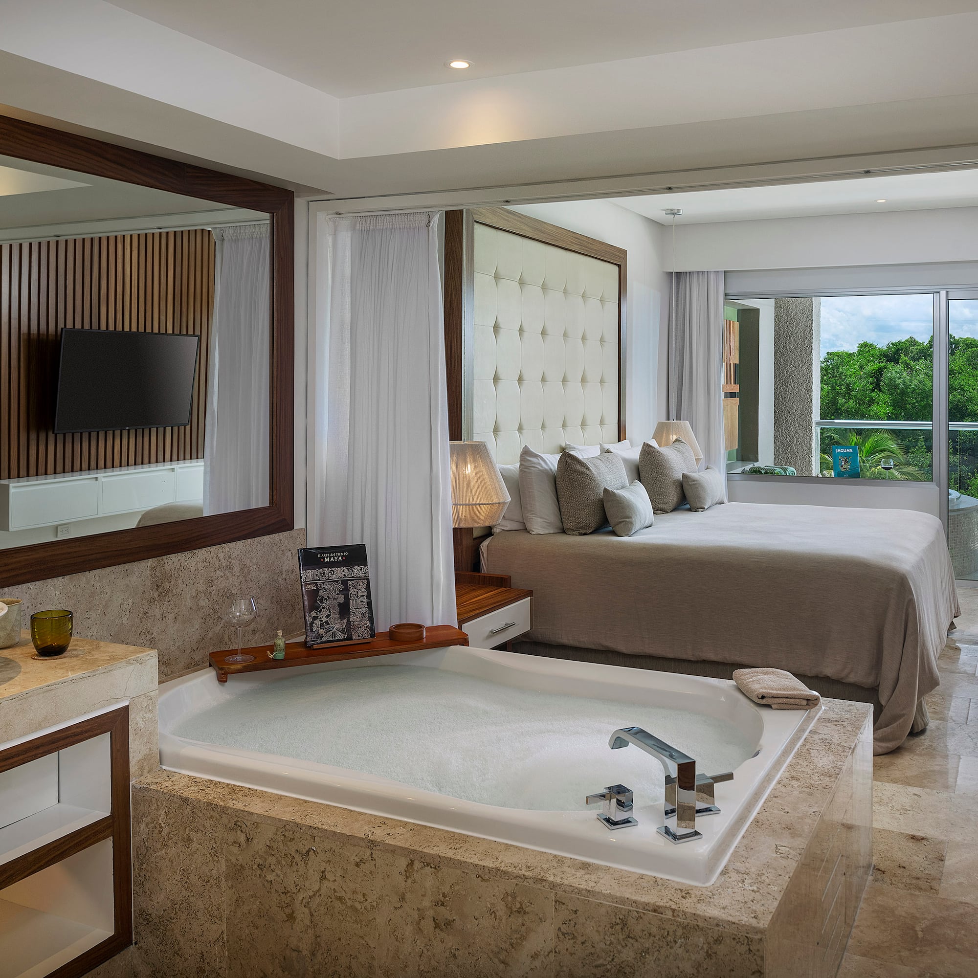 a room with a large tub and a bed