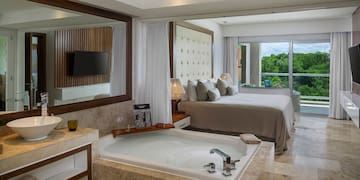 a room with a large tub and a bed