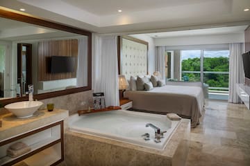 a room with a large tub and a bed