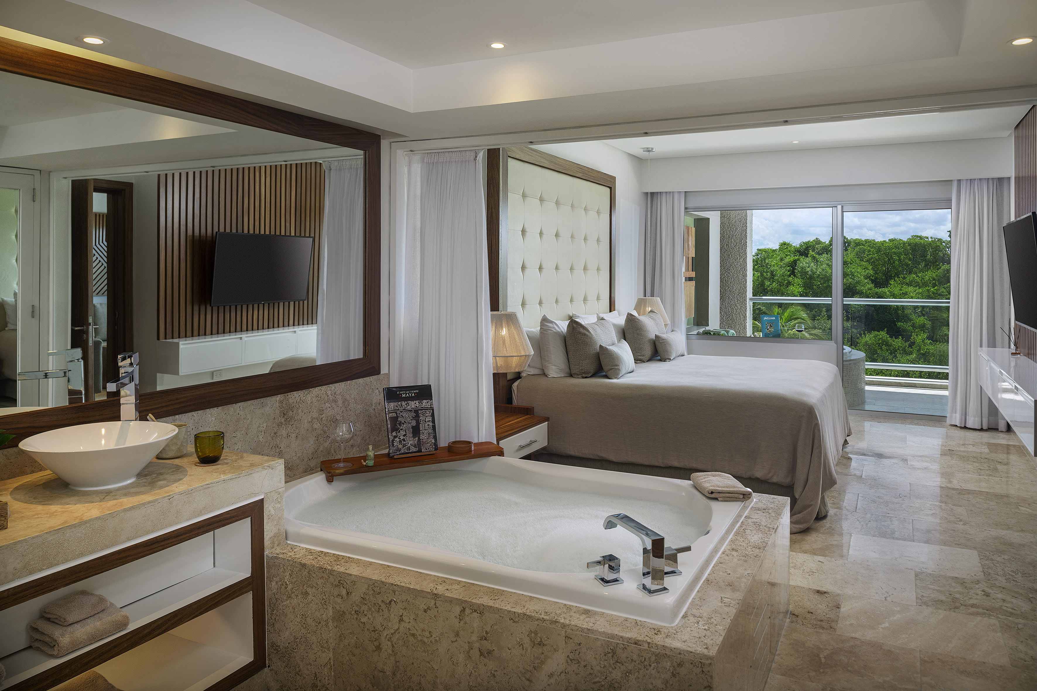 a room with a large tub and a bed