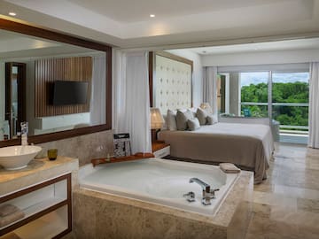 a room with a large tub and a bed