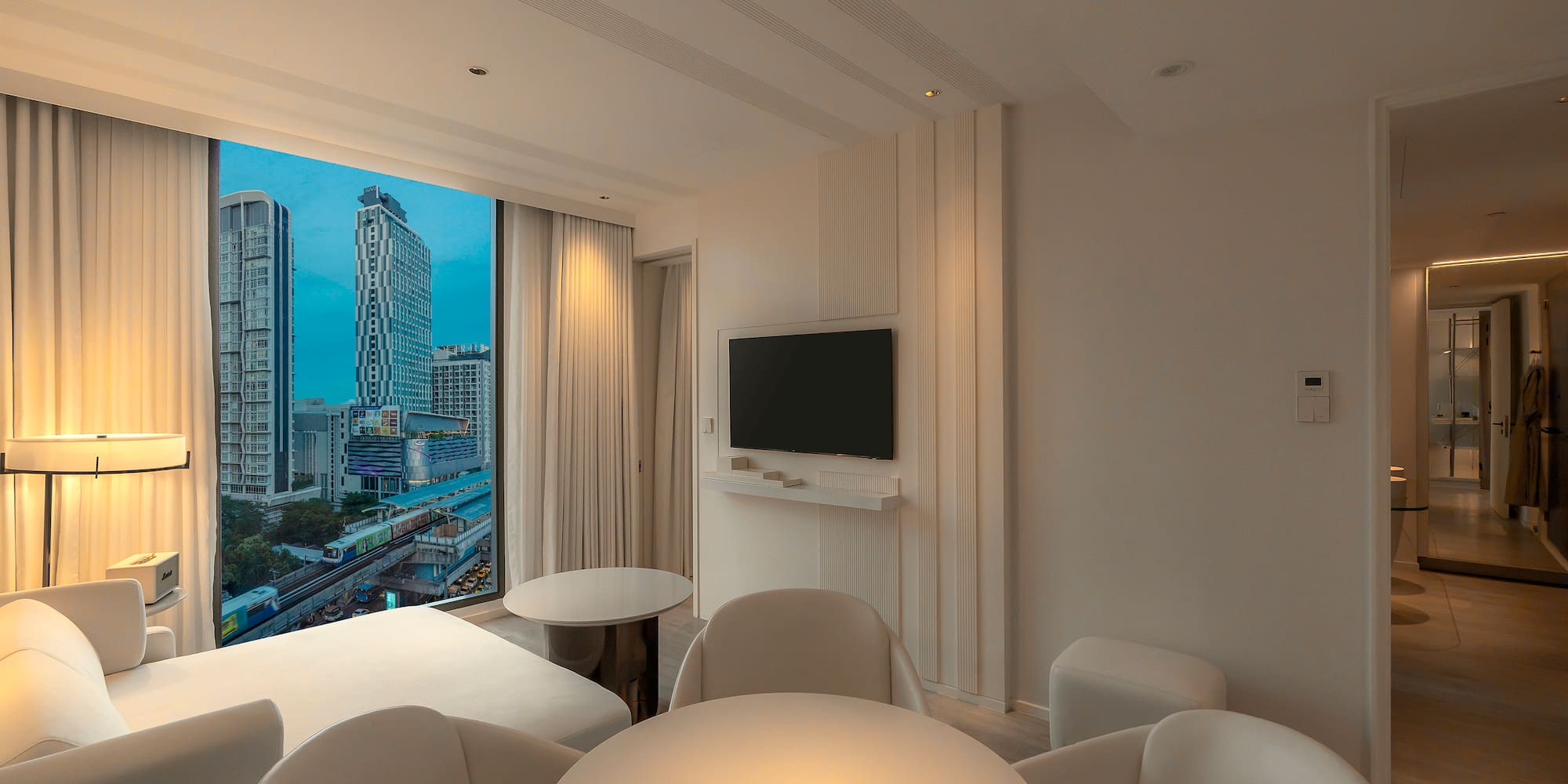 a room with a television and a city view