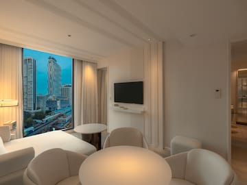 a room with a television and a city view