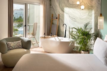 a room with a tub and a chair