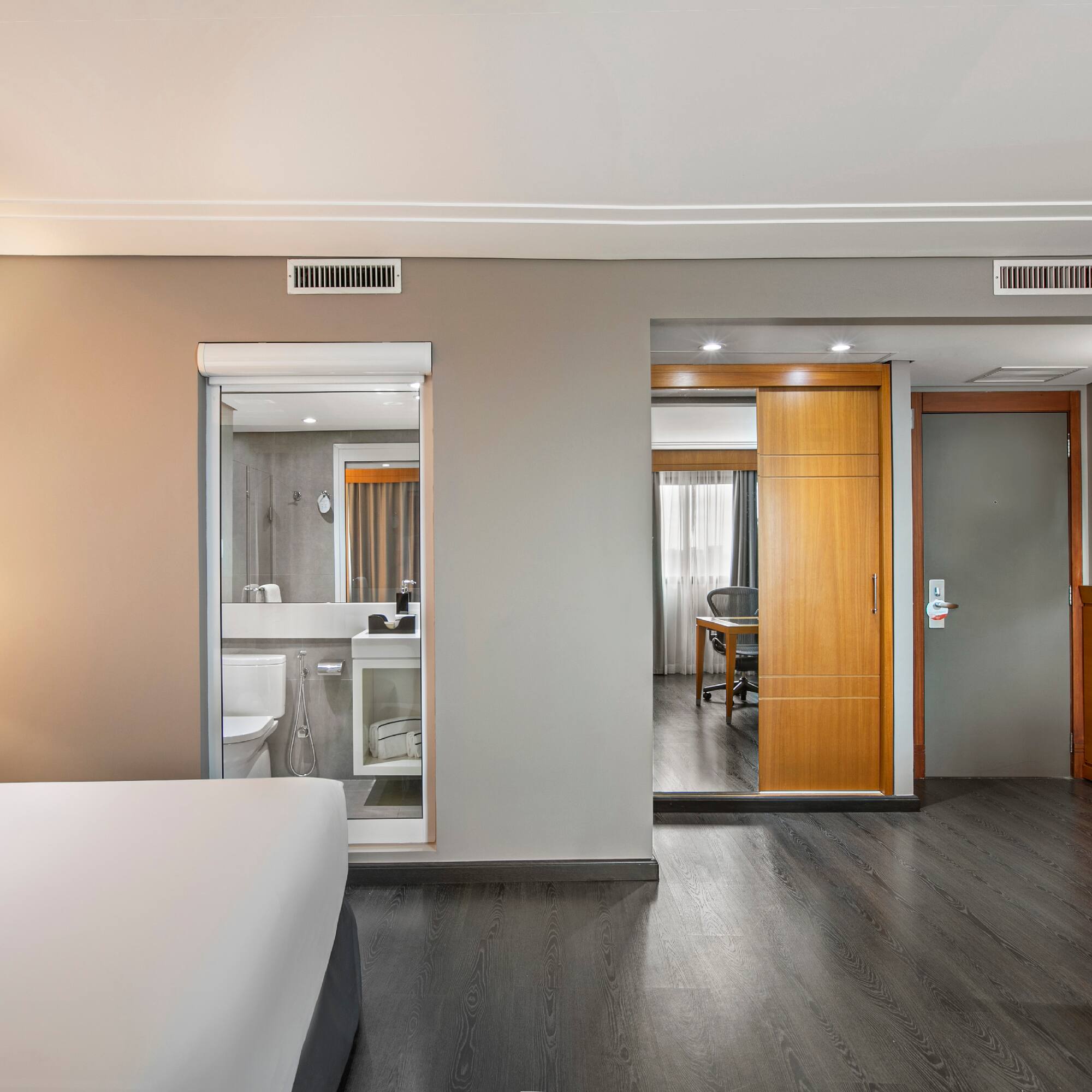 a bedroom with a wood floor and a wood door