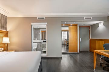 a bedroom with a wood floor and a wood door