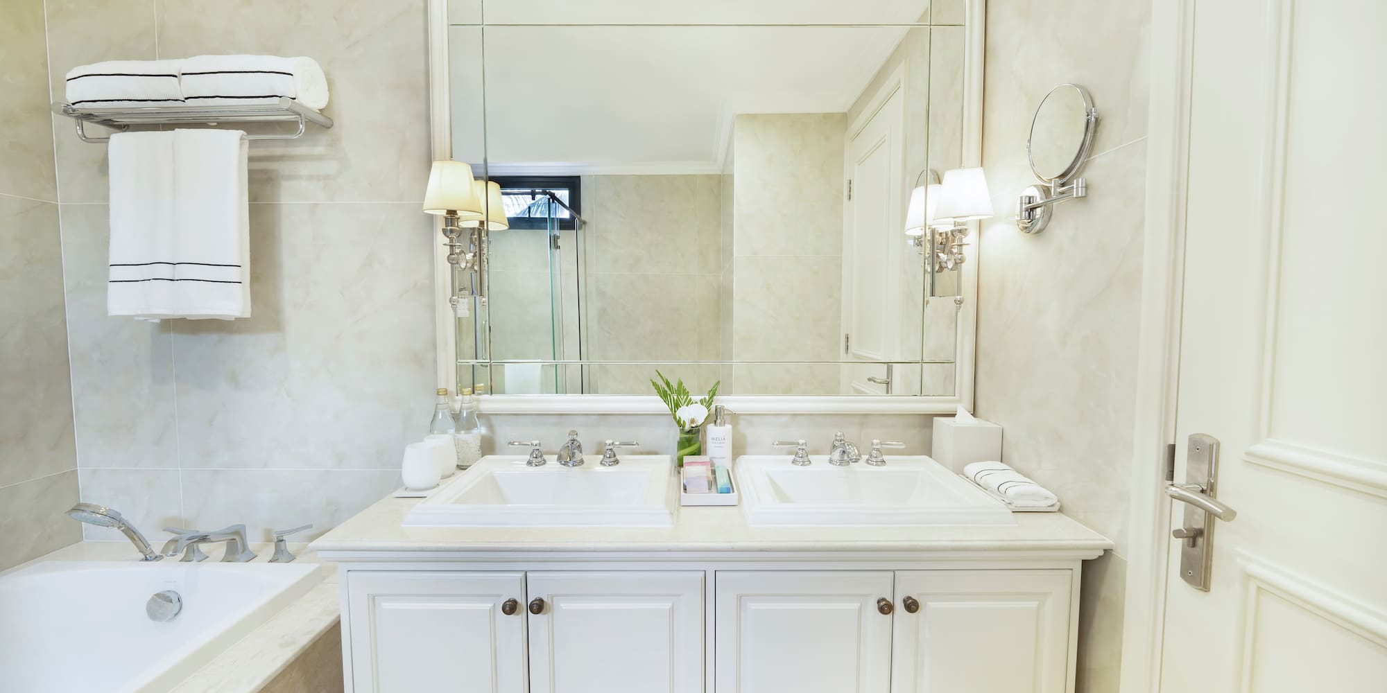 a bathroom with a large mirror and sink