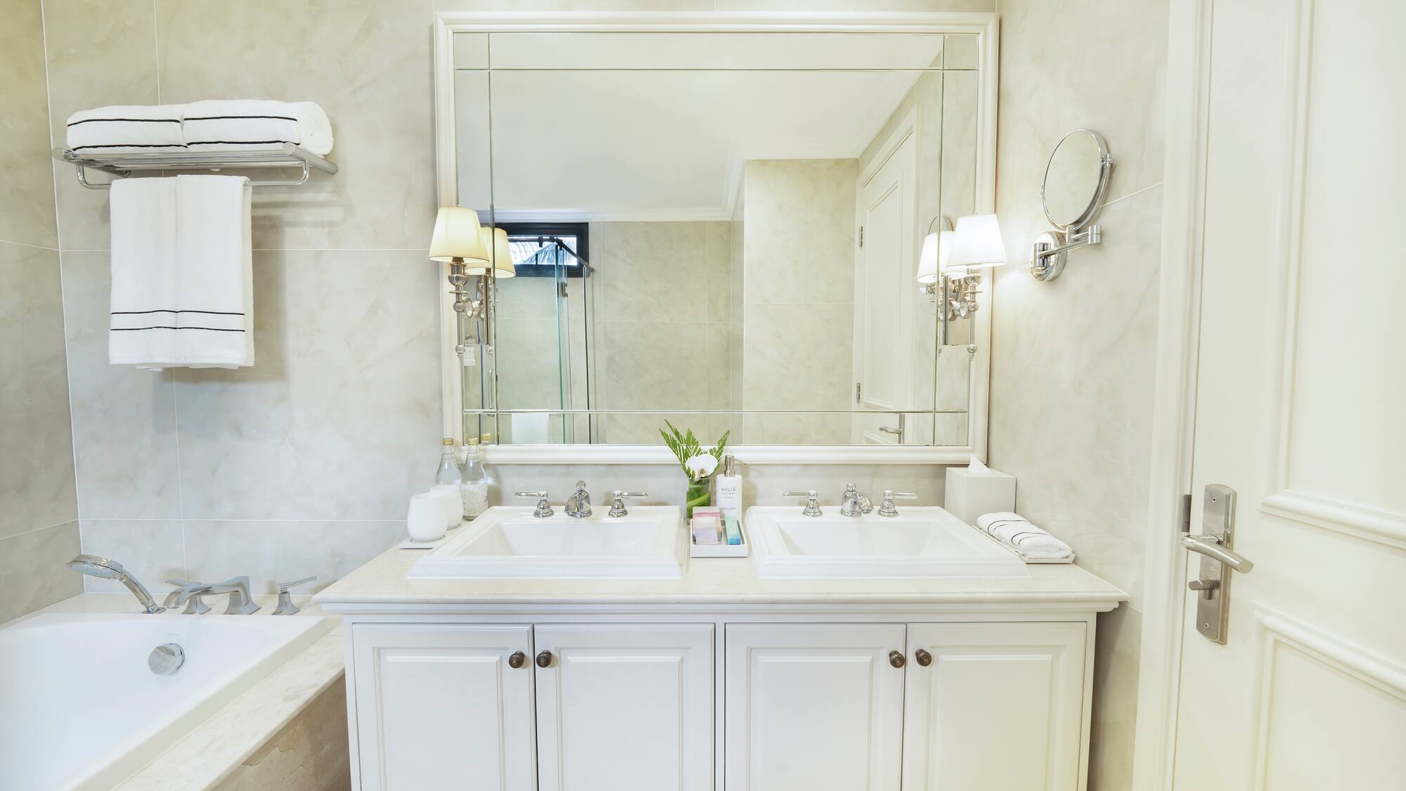 a bathroom with a large mirror and sink