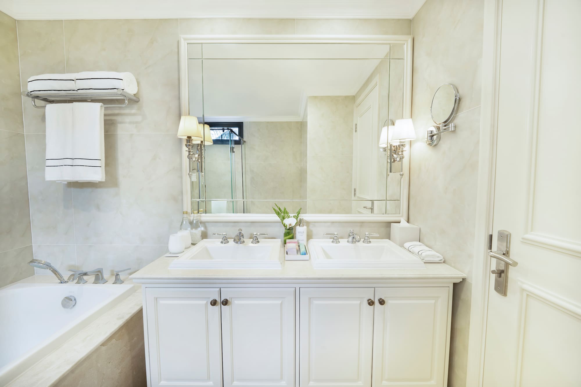 a bathroom with a large mirror and sink
