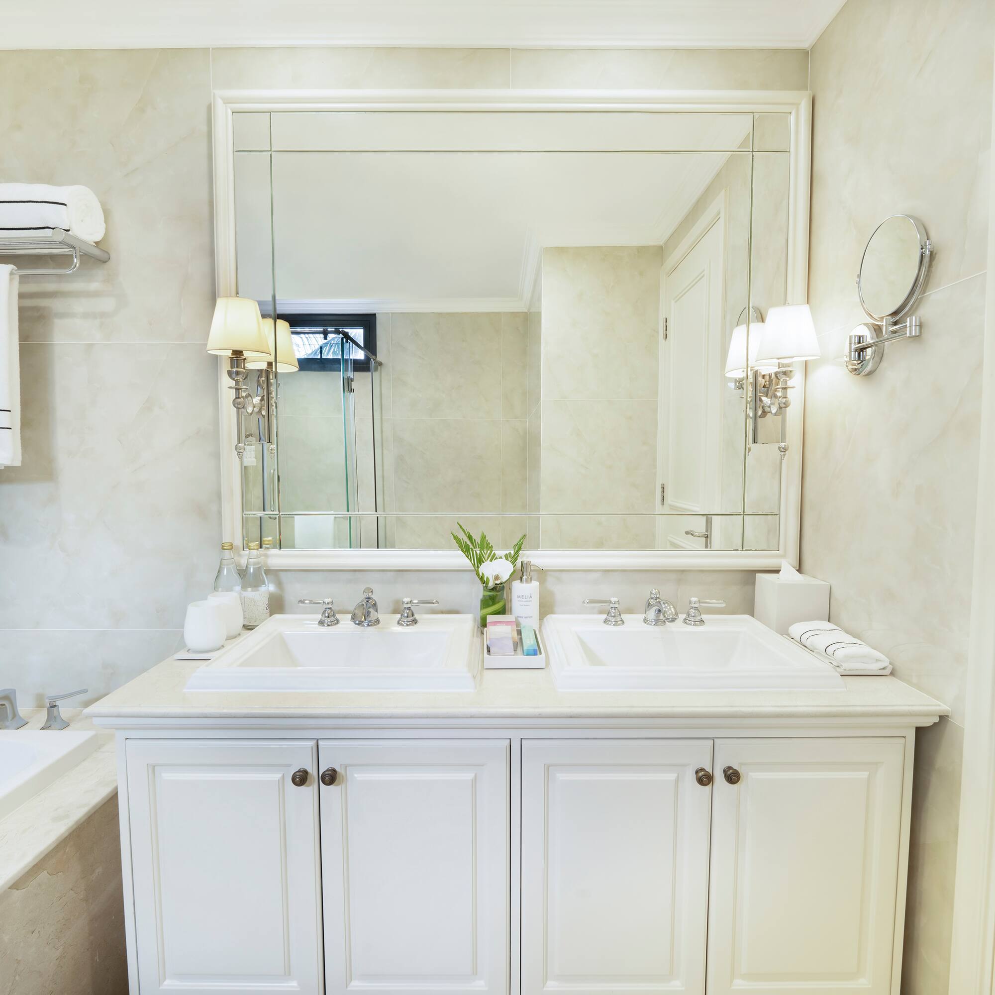 a bathroom with a large mirror and sink