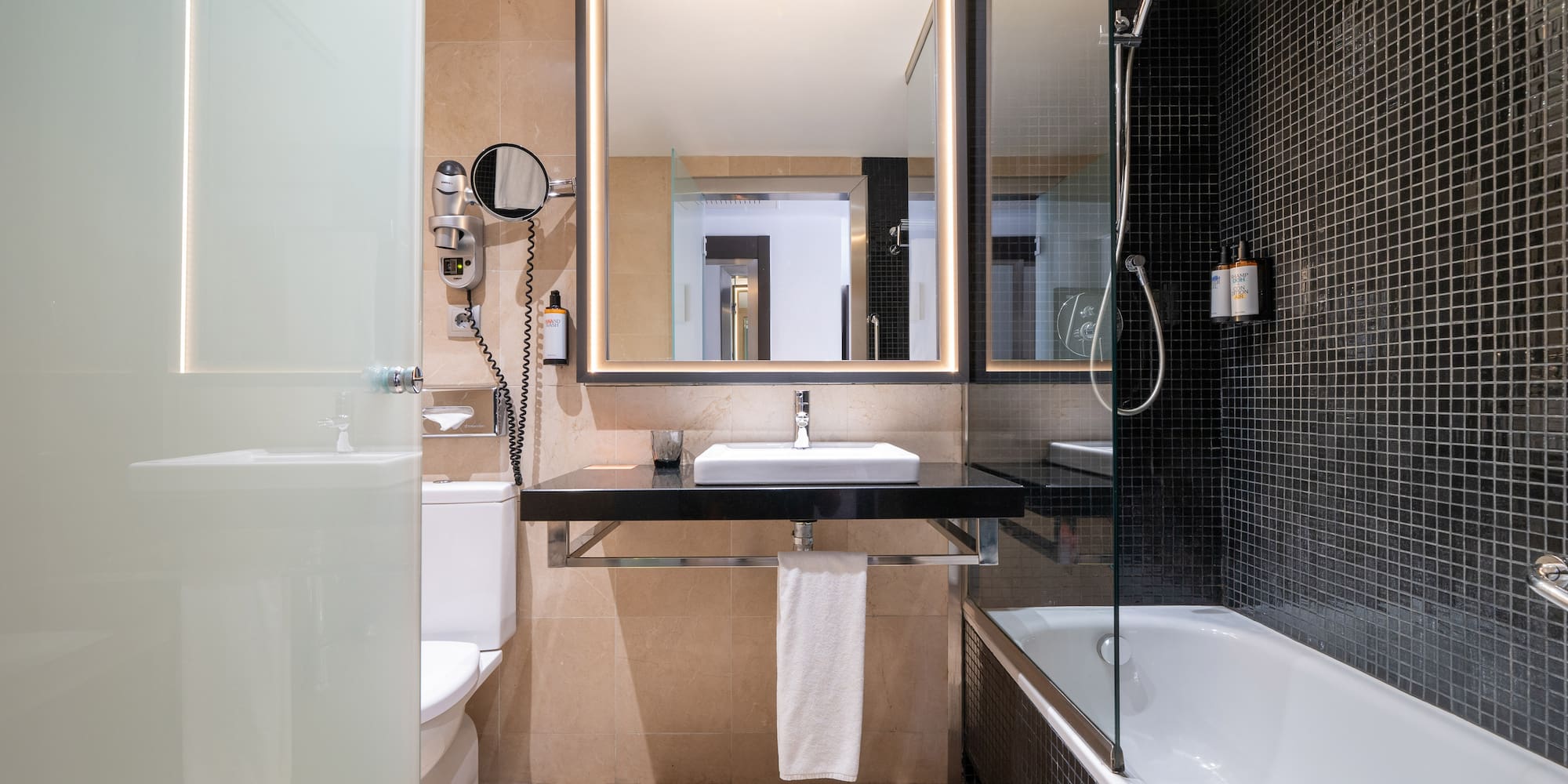 a bathroom with a mirror and a bathtub