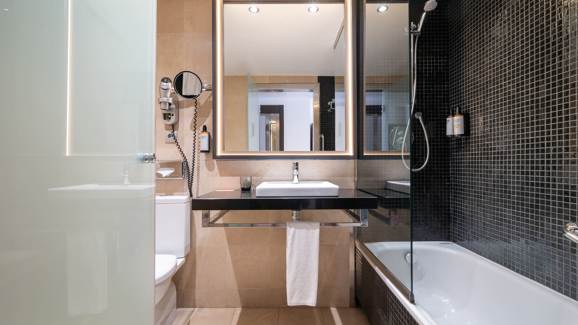 a bathroom with a mirror and a bathtub