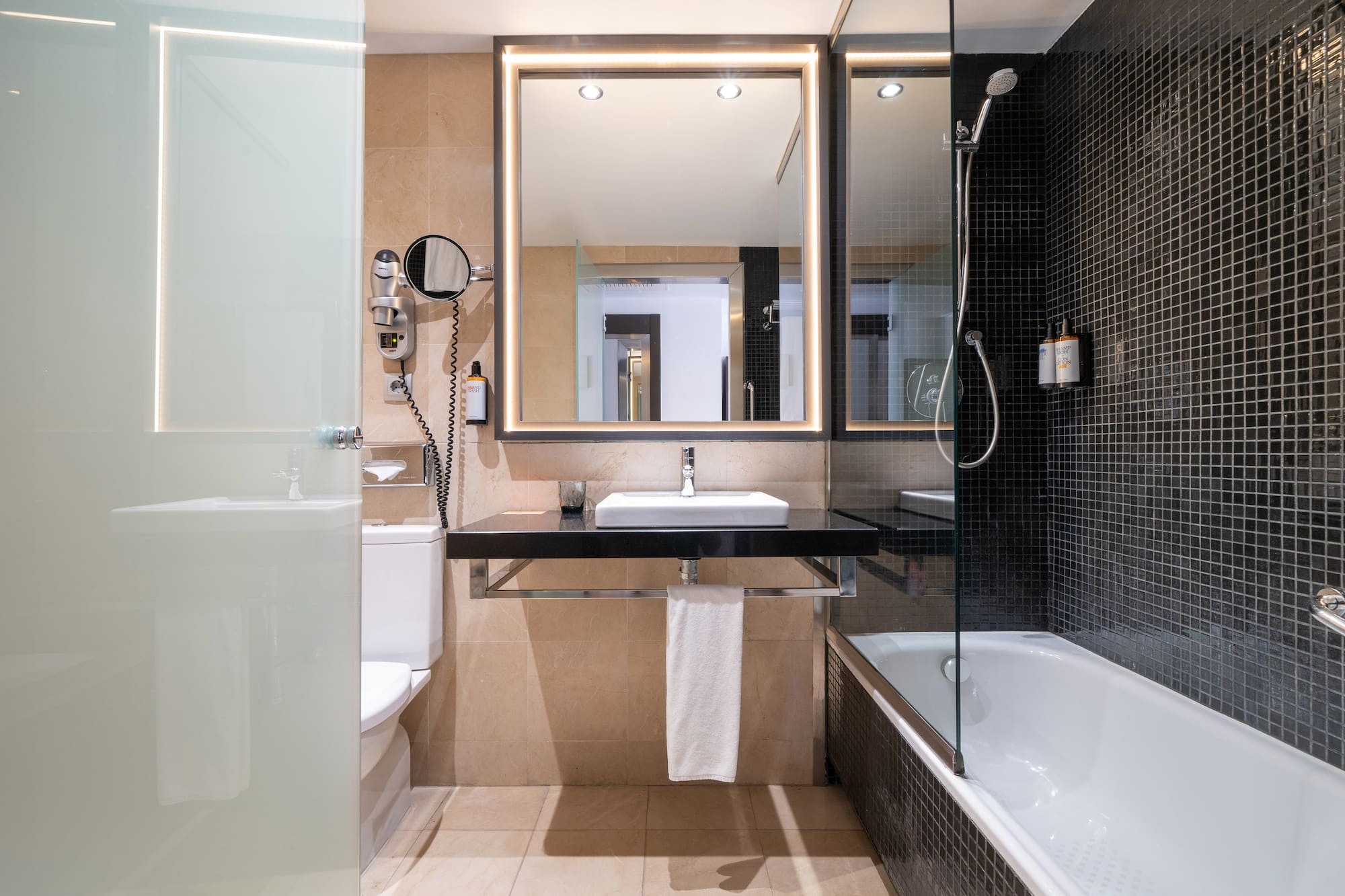 a bathroom with a mirror and a bathtub