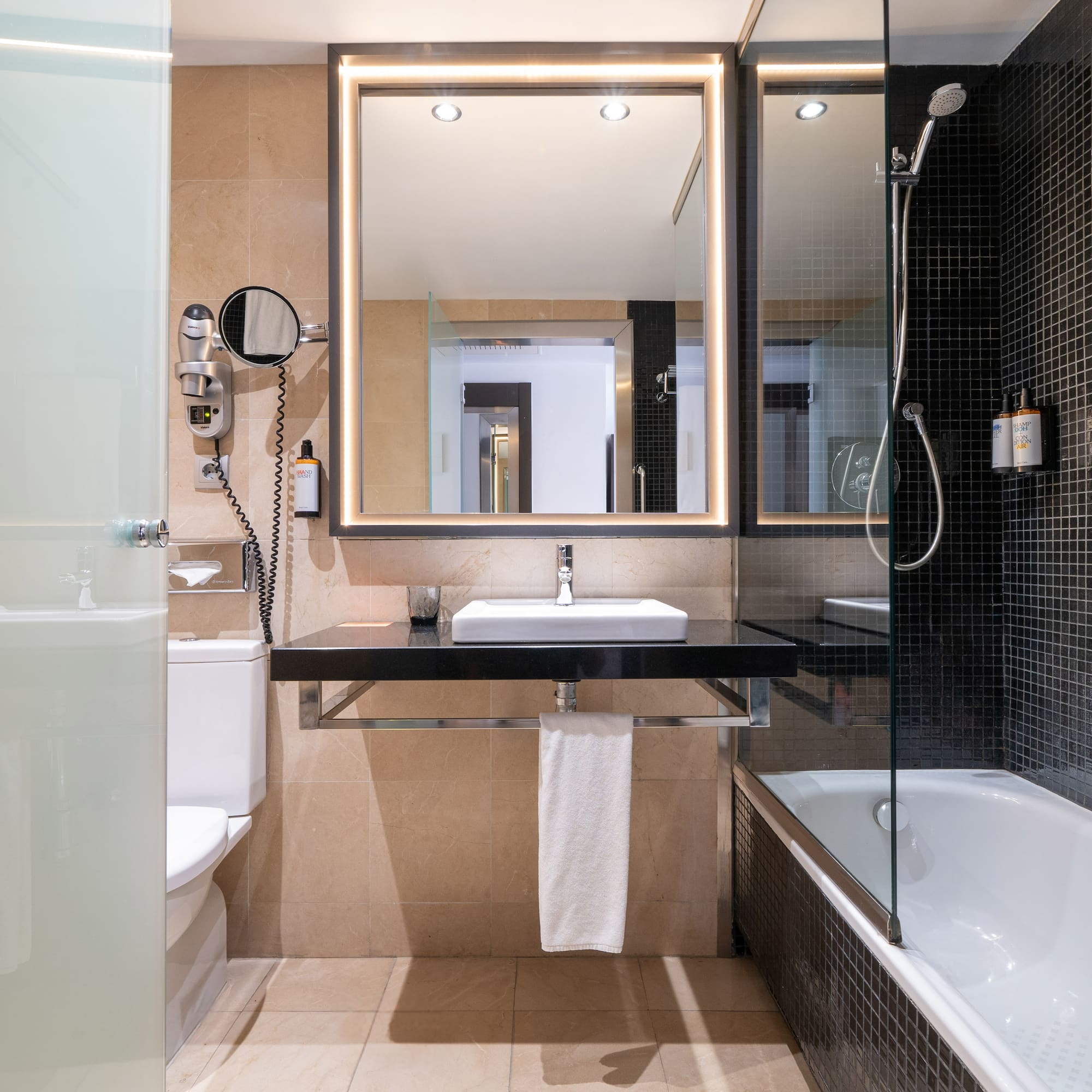 a bathroom with a mirror and a bathtub