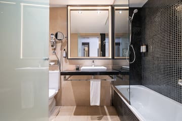 a bathroom with a mirror and a bathtub