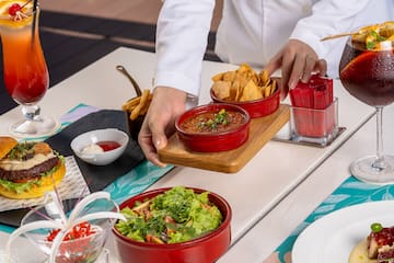 a person holding a tray of food