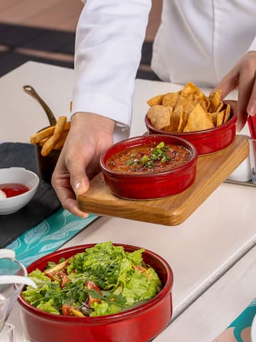 a person holding a tray of food