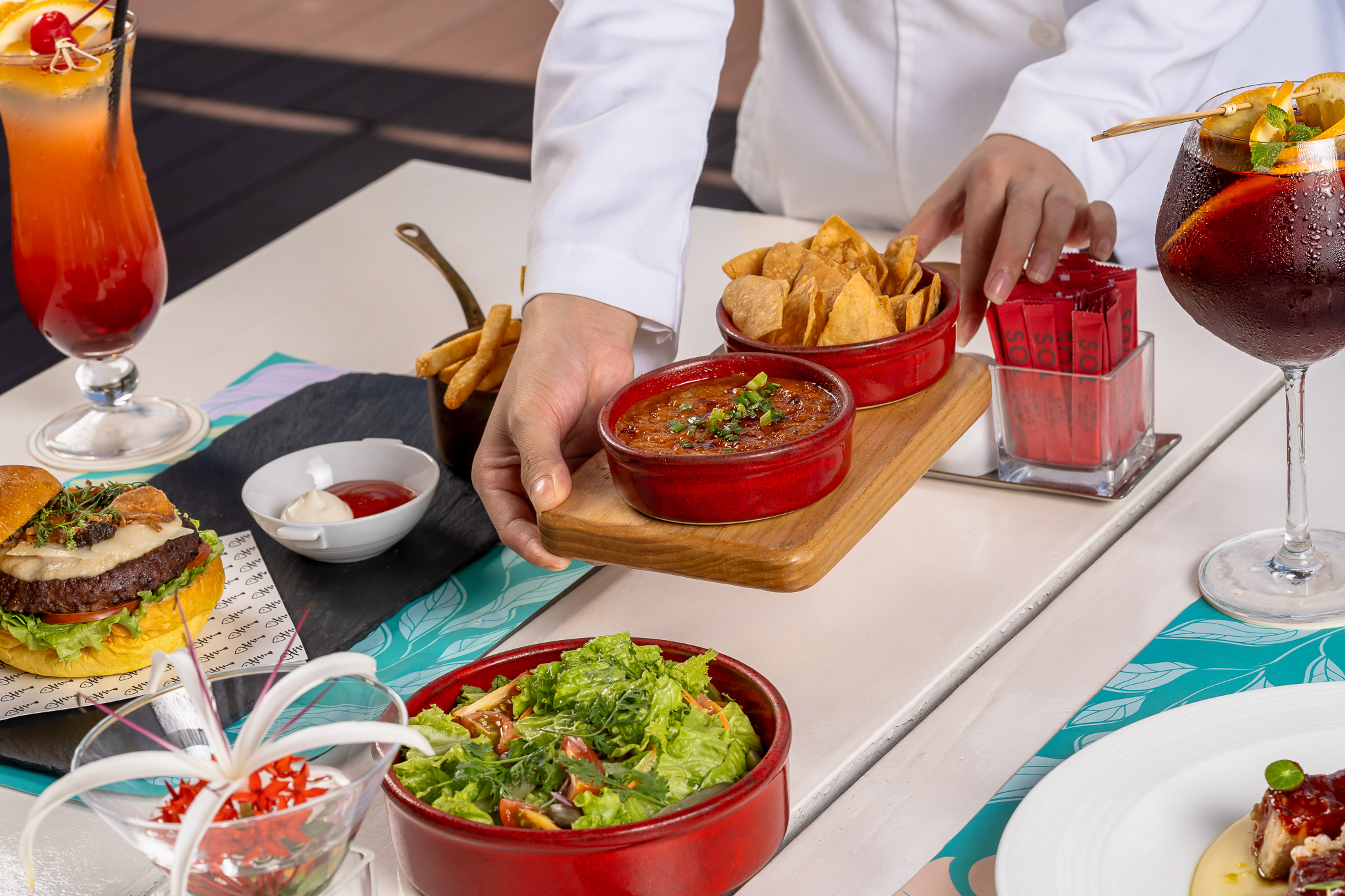 a person holding a tray of food