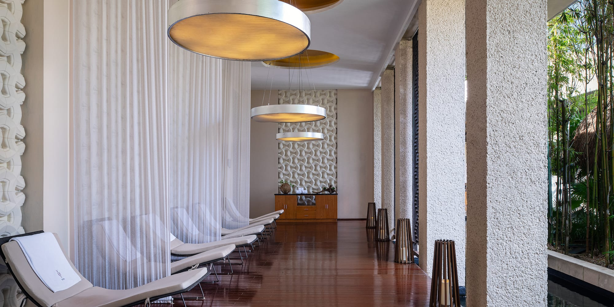 a long hallway with chairs and lights