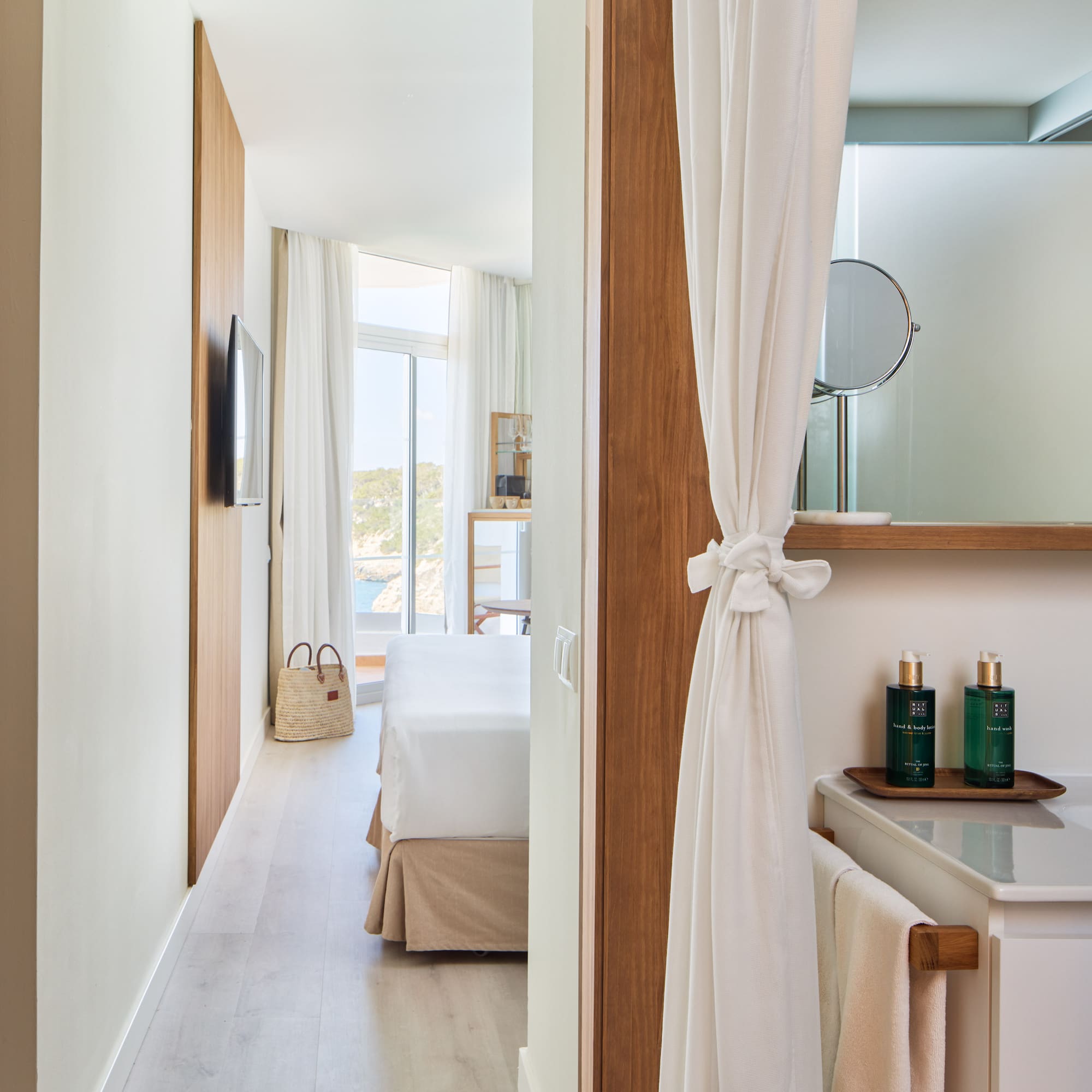 a room with a bed and a mirror