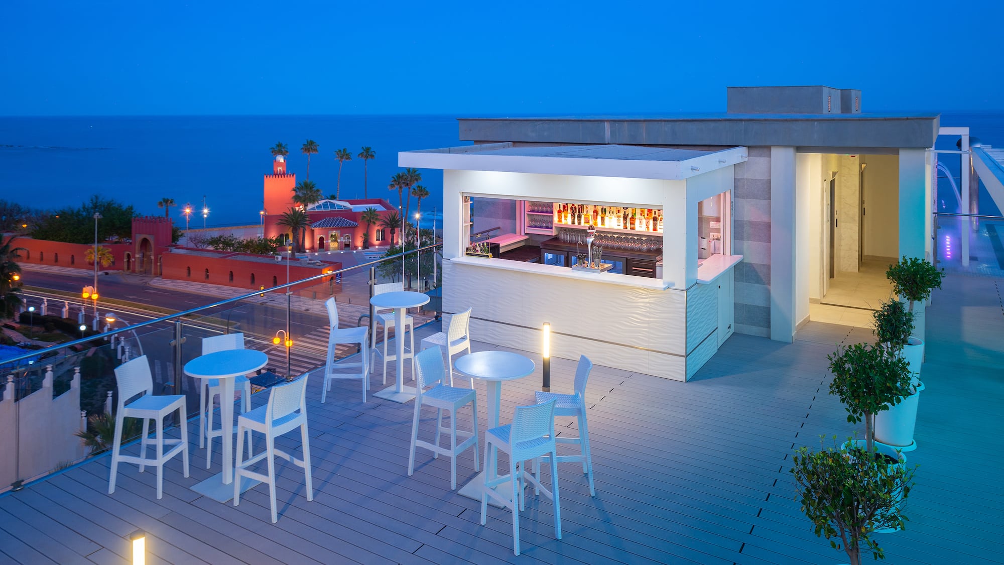 a rooftop bar with tables and chairs